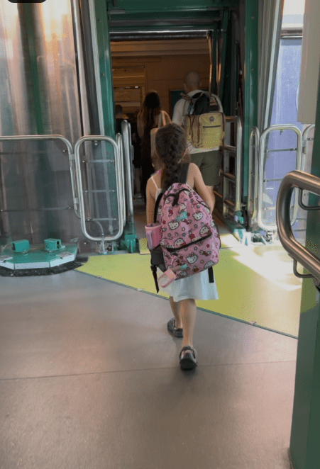 Girl and family walking to board the disney cruise ship. 