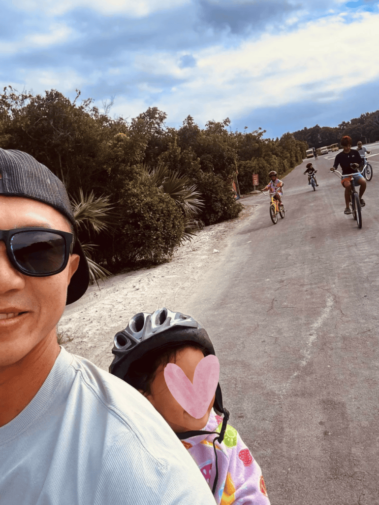 Picture of family bike riding on Castaway Cay Disney Island.