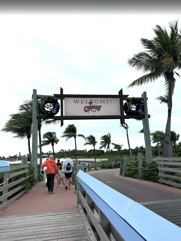 Picture of Castaway Cay sign on a cloudy windy day.